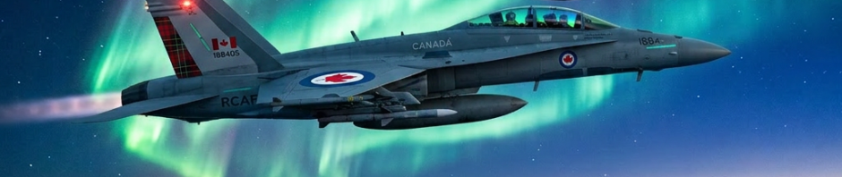 Two Navy fighter jets flying at night with northern lights in the sky above snowy mountains
