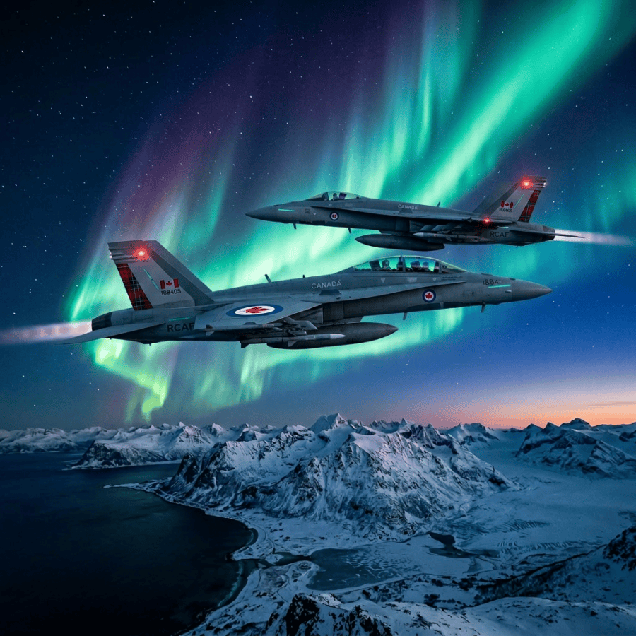 Two Navy fighter jets flying at night with northern lights in the sky above snowy mountains